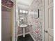 Charming powder room featuring floral wallpaper, pedestal sink and dark tile flooring at 1243 Williamswood Pointe, Decatur, GA 30033