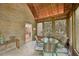 Charming sunroom with brick and wood paneled walls, tile floors, and natural light at 1243 Williamswood Pointe, Decatur, GA 30033