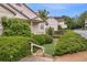 View of condo with beige exterior, manicured bushes, and staircase leading to front door at 203 Bridge Se Ln, Smyrna, GA 30082