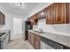 Galley kitchen with stainless steel appliances, granite countertops and warm wood cabinets at 203 Bridge Se Ln, Smyrna, GA 30082