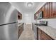 Modern galley kitchen featuring stainless steel appliances and granite countertops at 203 Bridge Se Ln, Smyrna, GA 30082