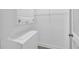Bright laundry room with stacked washer and dryer and wire shelving at 203 Bridge Se Ln, Smyrna, GA 30082