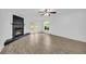 Bright living room featuring wood-look flooring, fireplace, and doors to an outdoor balcony at 203 Bridge Se Ln, Smyrna, GA 30082