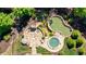 Aerial view of the home's outdoor living with a putting green, patio, and hot tub at 341 Carl Sanders Dr, Acworth, GA 30101