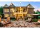 Exterior of brick house with a backyard stone patio and string lights at 341 Carl Sanders Dr, Acworth, GA 30101