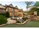 Backyard featuring an outdoor hot tub, patio with stone fireplace and seating at 341 Carl Sanders Dr, Acworth, GA 30101