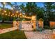 Backyard stone patio with string lights and stone fireplace at 341 Carl Sanders Dr, Acworth, GA 30101