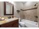 Bathroom with a granite countertop, a bathtub with tile accents, and dark wood vanity at 341 Carl Sanders Dr, Acworth, GA 30101