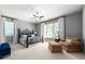 Bright bedroom featuring large windows, comfortable seating area, and a stylish bed at 341 Carl Sanders Dr, Acworth, GA 30101