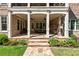 Beautiful covered patio with stone flooring, dining area, and brick columns at 341 Carl Sanders Dr, Acworth, GA 30101
