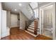 Grand foyer showcasing hardwood floors, elegant staircase, and access to powder room at 341 Carl Sanders Dr, Acworth, GA 30101