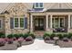 Charming front porch featuring stone accents, decorative columns and black wrought iron doors at 341 Carl Sanders Dr, Acworth, GA 30101
