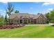 Charming brick and stone home featuring a lush lawn and manicured landscaping at 341 Carl Sanders Dr, Acworth, GA 30101