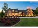 Beautiful stone and brick home featuring a lush, landscaped front yard and well-lit exterior at 341 Carl Sanders Dr, Acworth, GA 30101