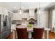 Spacious kitchen with stainless steel appliances, island with granite countertop and two pendant lights at 341 Carl Sanders Dr, Acworth, GA 30101