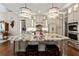 Spacious kitchen featuring a large center island, stainless steel appliances and gorgeous lighting at 341 Carl Sanders Dr, Acworth, GA 30101