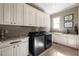 Well-equipped laundry room with new appliances, ample cabinet space, and a granite countertop at 341 Carl Sanders Dr, Acworth, GA 30101