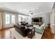 Spacious living room with hardwood floors, a large sectional, and an open floor plan at 341 Carl Sanders Dr, Acworth, GA 30101