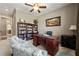 Spacious office area with beautiful shelves, a ceiling fan, and cozy seating for guests at 341 Carl Sanders Dr, Acworth, GA 30101