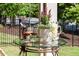 Outdoor table with wine glasses, ice bucket, and flowers surrounded by lush greenery at 341 Carl Sanders Dr, Acworth, GA 30101