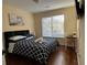 Cozy bedroom with hardwood floors, desk, and a bright window at 737 Cooper Sw St, Atlanta, GA 30315