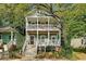 Charming two-story home with dual front porches surrounded by lush trees at 737 Cooper Sw St, Atlanta, GA 30315