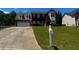 Charming two-story brick home with attached two car garage, manicured lawn, and long driveway at 8529 Glendevon Ct, Riverdale, GA 30274