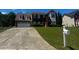 Charming two-story brick home with attached two car garage, manicured lawn, and long driveway at 8529 Glendevon Ct, Riverdale, GA 30274