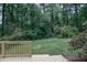 View of the backyard and lush green forest from the wooden deck at 1341 Timbercrest Ct, Lawrenceville, GA 30045