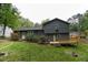 View of home's backyard with mature trees, a wooden deck, and established landscaping at 1341 Timbercrest Ct, Lawrenceville, GA 30045