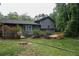 Exterior back view of home featuring gray siding and a wooden deck overlooking the yard at 1341 Timbercrest Ct, Lawrenceville, GA 30045
