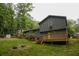Exterior back of home with gray siding, a wooden deck, and large backyard at 1341 Timbercrest Ct, Lawrenceville, GA 30045