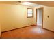 Finished basement space with a window, carpet, and access to another room at 1341 Timbercrest Ct, Lawrenceville, GA 30045