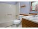 This bathroom features a shower/tub combo, toilet, sink with cabinet, and a window with curtains at 1341 Timbercrest Ct, Lawrenceville, GA 30045