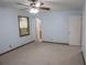 This bedroom features light blue walls, neutral carpet, a ceiling fan, and a window with an AC unit at 1341 Timbercrest Ct, Lawrenceville, GA 30045