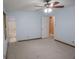 This bedroom features light blue walls, neutral carpet, a ceiling fan, and a window with an AC unit at 1341 Timbercrest Ct, Lawrenceville, GA 30045