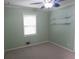 Bedroom features light-green walls, neutral carpet, window, and ceiling fan at 1341 Timbercrest Ct, Lawrenceville, GA 30045