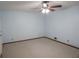Bedroom features light-blue walls, neutral carpet, and ceiling fan at 1341 Timbercrest Ct, Lawrenceville, GA 30045