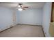 Bedroom features light-blue walls, neutral carpet, and ceiling fan at 1341 Timbercrest Ct, Lawrenceville, GA 30045