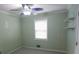 Bedroom features light-green walls, neutral carpet, window, and ceiling fan at 1341 Timbercrest Ct, Lawrenceville, GA 30045