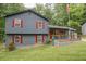 View of a two-story home with gray siding, red shutters, and a well-maintained lawn at 1341 Timbercrest Ct, Lawrenceville, GA 30045