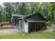 Rear exterior view of a home with gray siding and a covered storage area at 1341 Timbercrest Ct, Lawrenceville, GA 30045