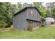Side view of a home with gray siding and red shutters, showing the yard at 1341 Timbercrest Ct, Lawrenceville, GA 30045