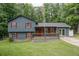 Charming two-story home featuring gray siding, red shutters, and a welcoming front porch at 1341 Timbercrest Ct, Lawrenceville, GA 30045