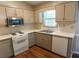 Kitchen view with stainless steel microwave, dishwasher, and overhead cabinets at 1341 Timbercrest Ct, Lawrenceville, GA 30045