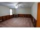 A spacious living room boasts paneled walls, neutral carpet, and an electric fireplace at 1341 Timbercrest Ct, Lawrenceville, GA 30045