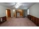 A spacious living room boasts paneled walls, neutral carpet, and closet doors at 1341 Timbercrest Ct, Lawrenceville, GA 30045