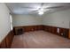 A spacious living room boasts paneled walls, neutral carpet, and an electric fireplace at 1341 Timbercrest Ct, Lawrenceville, GA 30045