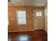 Living room featuring hardwood floors, natural light, and a white door at 1341 Timbercrest Ct, Lawrenceville, GA 30045