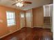 Cozy living room with hardwood floors, ceiling fan, and stairs to the upper level at 1341 Timbercrest Ct, Lawrenceville, GA 30045